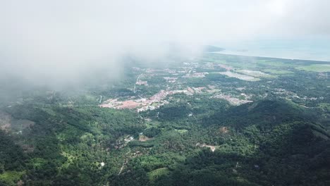 Aerial-over-Balik-Pulau,-Pulau-Pinang.-Foggy-sky-before-the-rain.